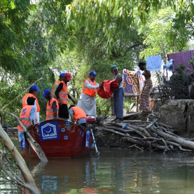 Volunteers from the Al-Khidmat Foundation are using boats to reach isolated villages in the vasted flooded plains of Sindh