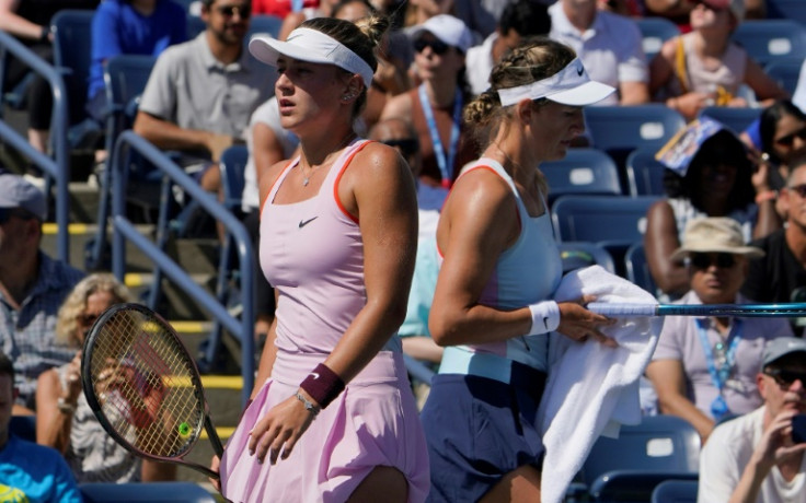 Different outlooks: Belarus' Victoria Azarenka (right) and Marta Kostyuk of Ukraine