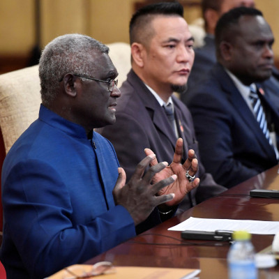 Solomon Islands Prime Minister Manasseh Sogavare talks to Chinese President Xi Jinping during their meeting at the Diaoyutai State Guesthouse in Beijing