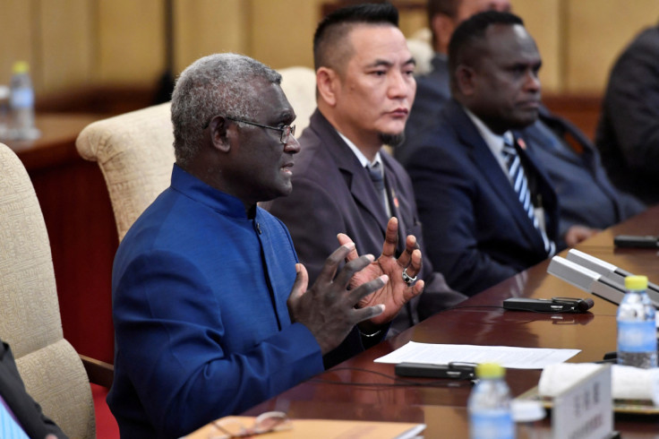 Solomon Islands Prime Minister Manasseh Sogavare talks to Chinese President Xi Jinping during their meeting at the Diaoyutai State Guesthouse in Beijing