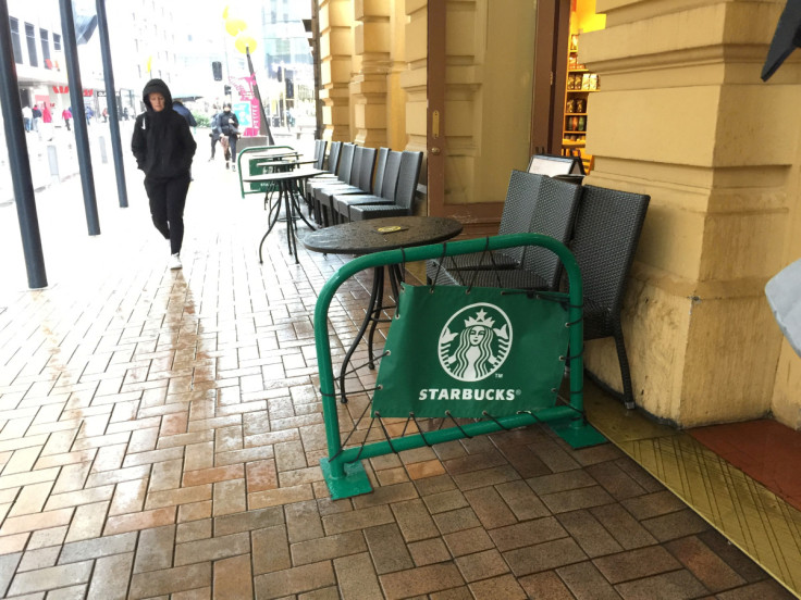 A pedestrian walks past a Starbucks cafe in central Wellington