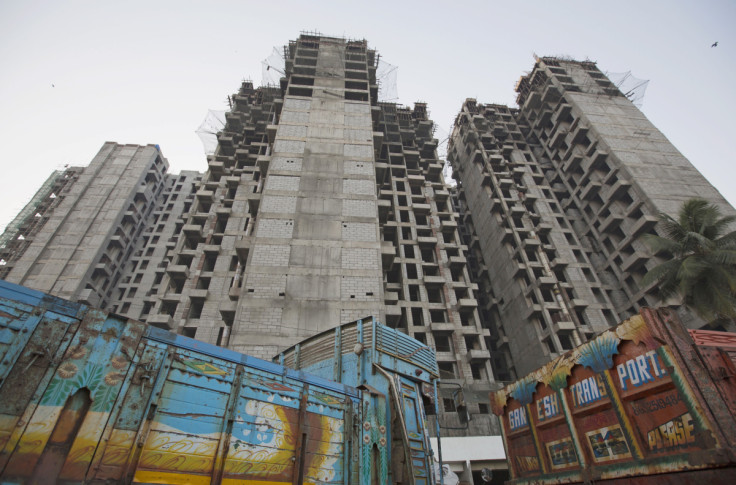 Trucks are parked at the site of an under-construction residential building project, which has been stalled, in Mumbai