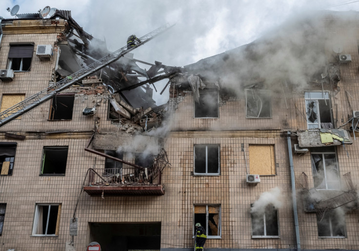 Firefighters work at the site of a residential building hit by a Russian military strike in Kharkiv