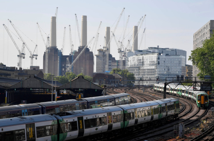 Trains pass near construction work taking place around Battersea Power Station in London, Britain