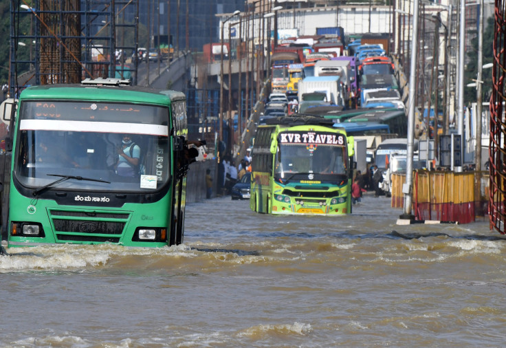 Traffic moves through a water-logged road following torrential rains in Bengaluru