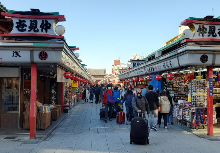 Tourists wearing protective face masks following an outbreak of the coronavirus disease are seen at Asakusa district in Tokyo, Japan