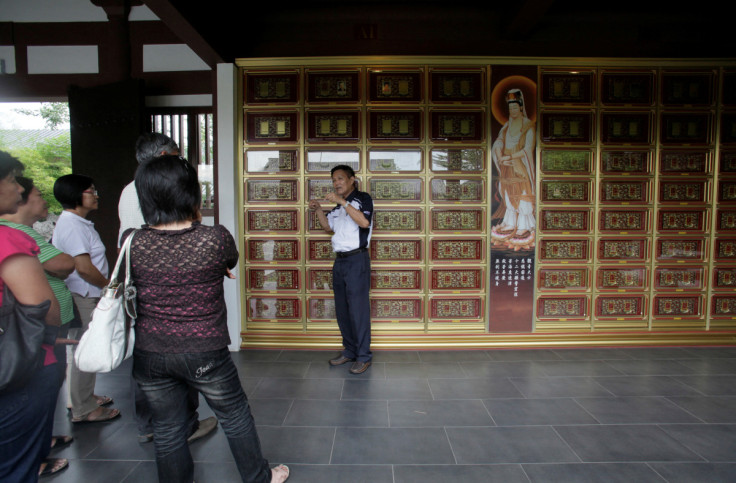 A salesperson talks to potential customers at the columbarium section of Nirvana Memorial Park in Shah Alam outside Kuala Lumpur September 5, 2010.