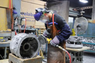 Workers at Mitchell Aerospace a manufacturer of light alloy sand castings for the aerospace industry