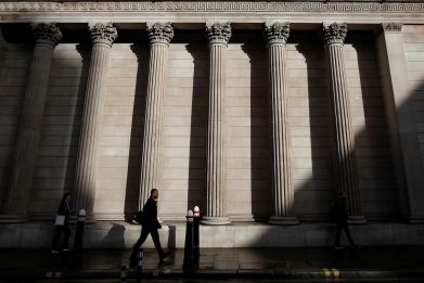 A commuter walks past the Bank of England, in London