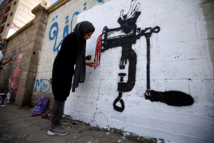 An artist paints a mural as part of the "Cholera"  campaign to depict the suffering of cholera patients in Sanaa