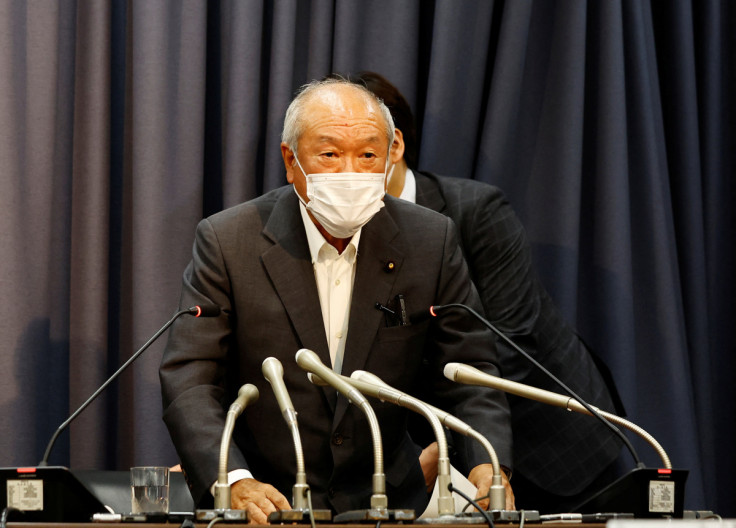 Japan's Finance Minister Shunichi Suzuki stands up from a table as he finishes his news conference after Japan intervened in the currency market for the first time since 1998 to shore up the battered yen in Tokyo