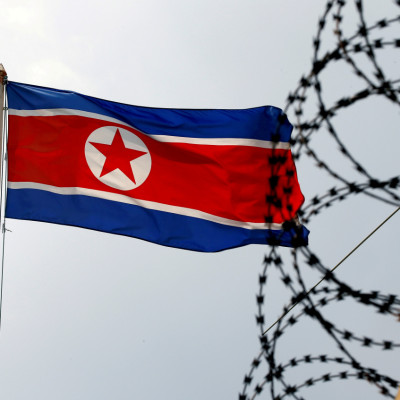 A North Korea flag flutters next to concertina wire at the North Korean embassy in Kuala Lumpur