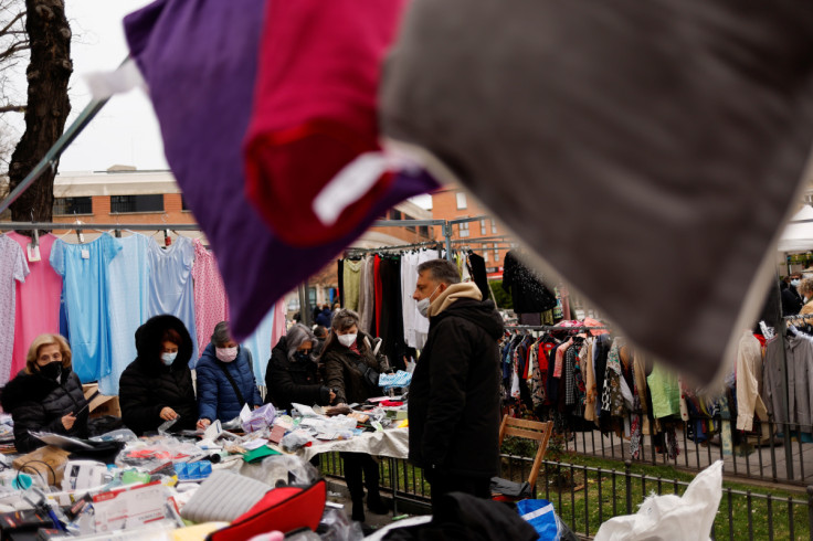 Women shop at a street market in Madrid