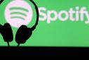 A headset is seen in front of a screen projection of Spotify logo, in this picture illustration