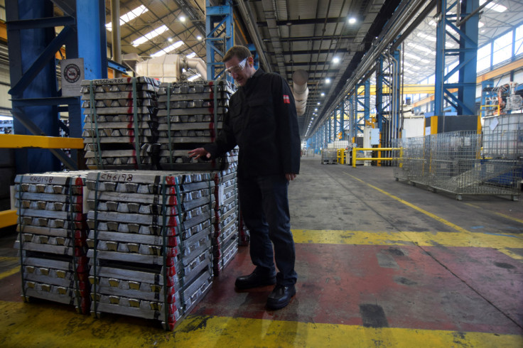 Brett Parker, business director of Evtec Aluminium Ltd, stands next to bars of recycled aluminium at the company's foundry, in Kidderminster