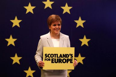 Scotland's First Minister Nicola Sturgeon stands in front of a European Union flag at the Scottish National Party (SNP) conference in Edinburgh