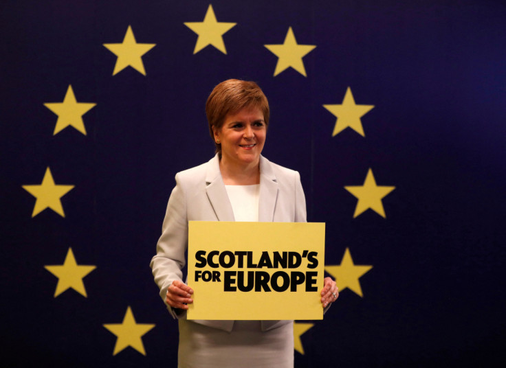 Scotland's First Minister Nicola Sturgeon stands in front of a European Union flag at the Scottish National Party (SNP) conference in Edinburgh