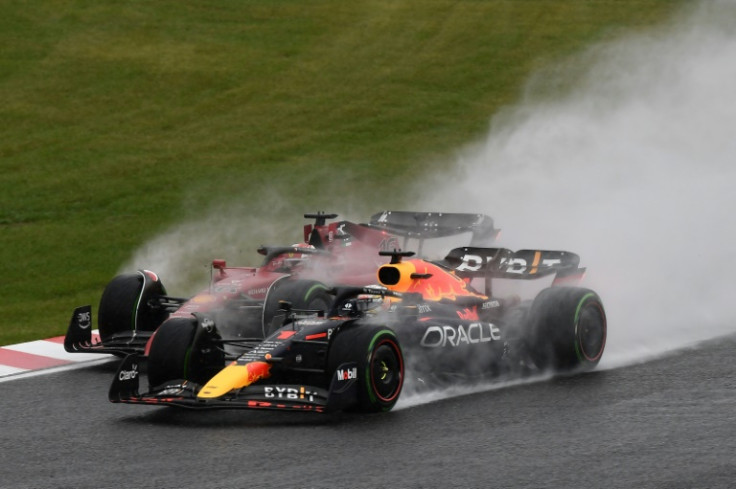 Max Verstappen (right) passes Ferrari's Charles Leclerc around the first turn in Japan