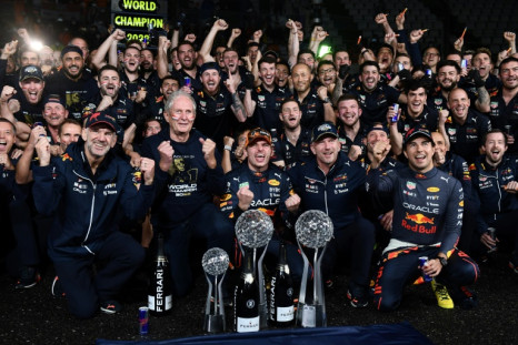 Max Verstappen (front, centre) and the entire Red Bull pit crew and team celebrate winning back-to-back world championships at Suzuka
