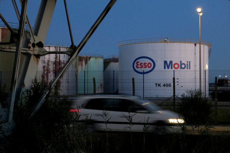 A car drives past a fuel tank of the ESSO rafinery in Pont-Jerome near le Havre