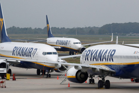 Ryanair airplane taxis past two parked aircraft at Weeze Airport