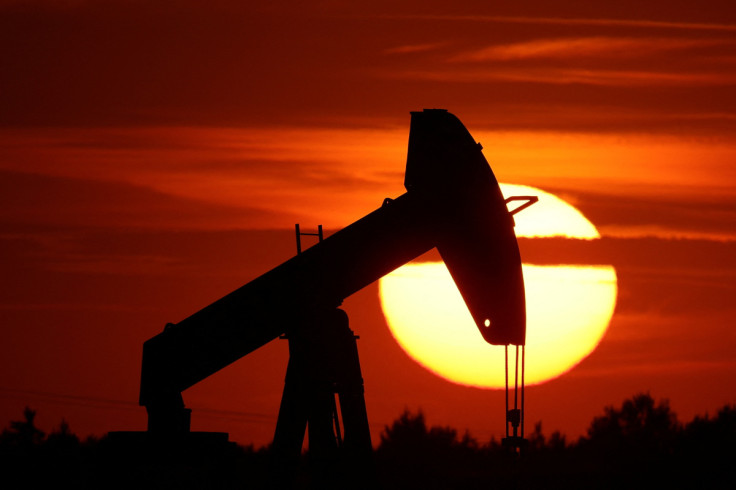 The sun sets behind an oil pump-jack outside Soudron