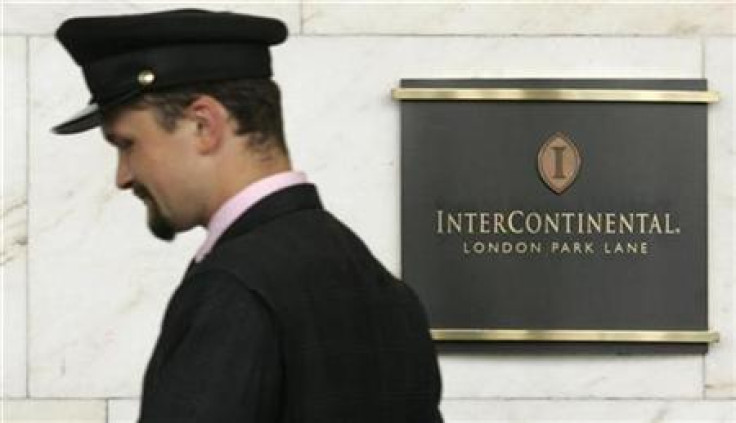 A porter passes a sign for the InterContinental Hotel Park Lane in London