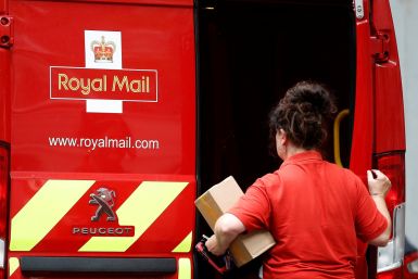 A postal worker makes a delivery in London
