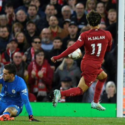 Liverpool forward Mohamed Salah scores against Manchester City at Anfield