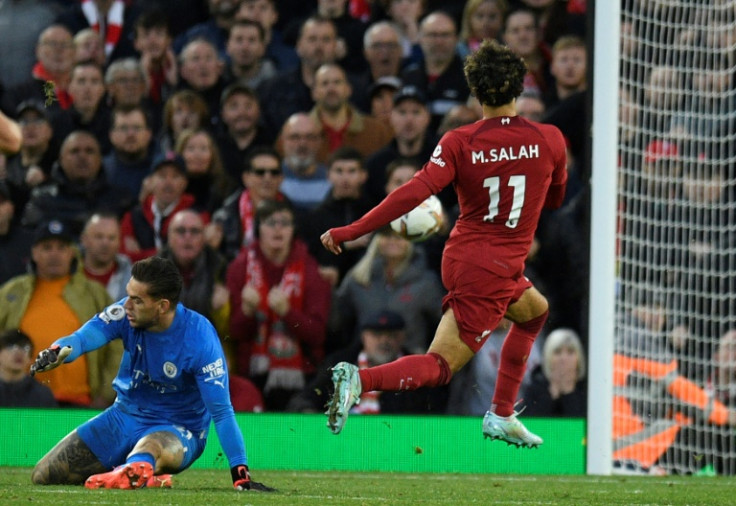 Liverpool forward Mohamed Salah scores against Manchester City at Anfield