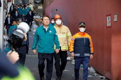 South Korean President Yoon Suk-yeol walks at the scene where many people died and were injured in a stampede during a Halloween festival in Seoul