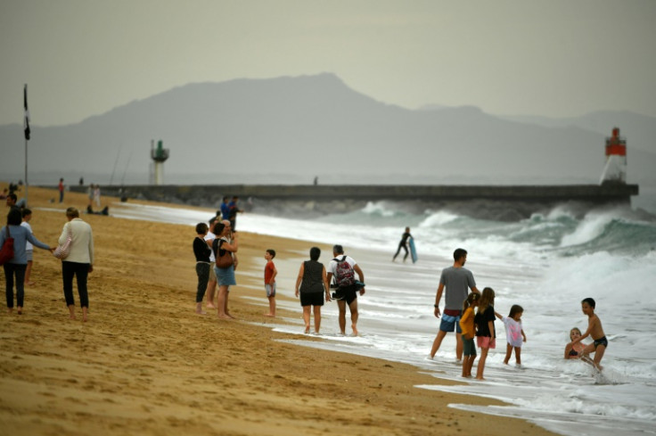 Warm October weather has seen many flock to the beach -- such as here at Hossegor, southwestern France -- but environmentalists see more evidence of climate change