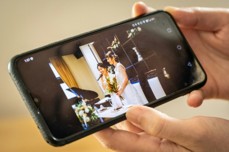 Miki shows a picture of her wedding to partner Katie following an interview with AFP at their home in Tokyo