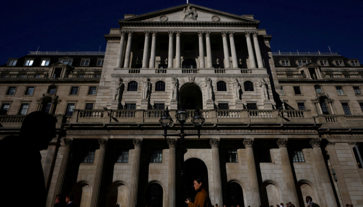 People walk outside the Bank of England in London