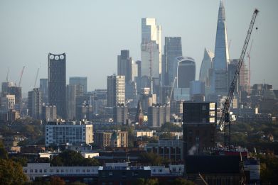 The City of London financial district can be seen in the distance beyond housing developments in London
