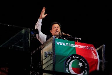 Ousted Pakistani Prime Minister Imran Khan gestures as he addresses supporters during a rally, in Lahore