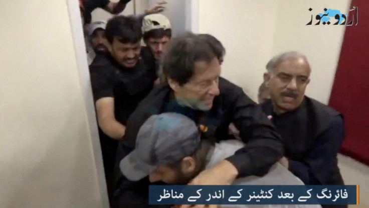 Former Pakistani Prime Minister Imran Khan is helped after he was shot in the shin in Wazirabad