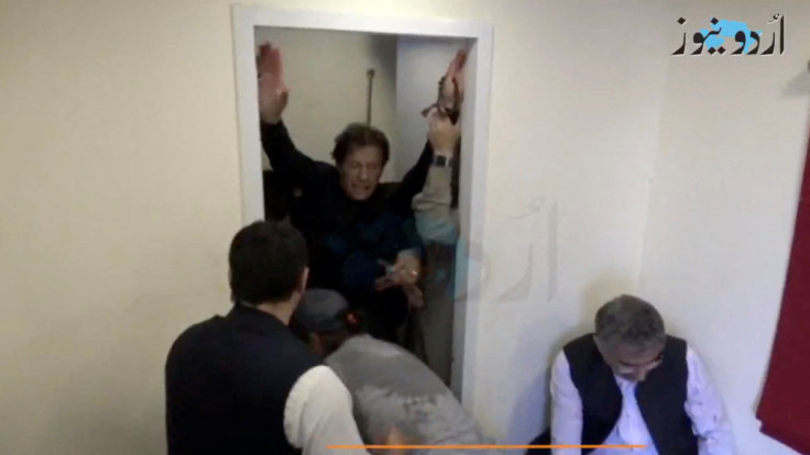 Former Pakistani Prime Minister Khan is helped after he was shot in the shin in Wazirabad