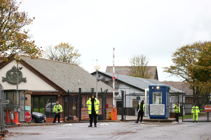 Security guards stand at the entrance to a migrant processing centre in Manston