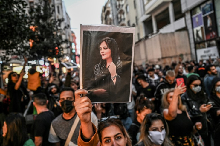 A protester in Istanbul, Turkey holds up a portrait of Mahsa Amini