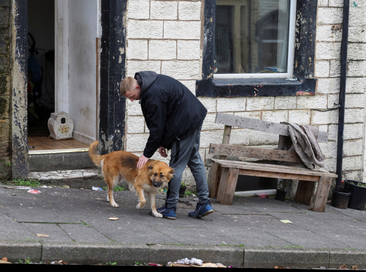 A man pats a dog in the parish of Matthew the Apostle Church in Burnley, England