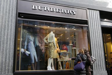 Two women stand in front of a store of British luxury brand Burberry in Zurich