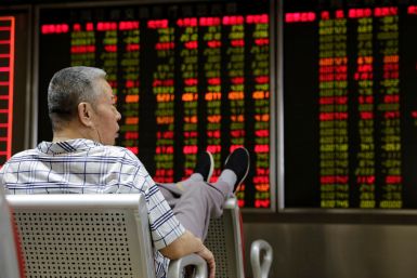 An investor watches stock prices at a brokerage office in Beijing