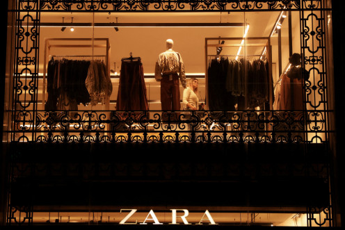 A customer looks at clothes at Zara store in Barcelona