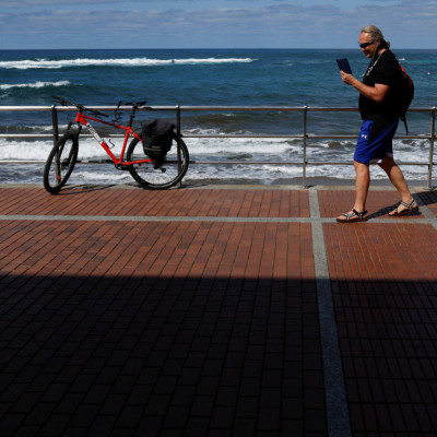 50-year-old Victor Varlamov talks on his phone from Las Canteras Beach Avenue in Las Palmas de Gran Canaria