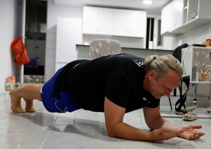 50-year-old Victor Varlamov exercises in the living room of his house in Las Palmas de Gran Canaria