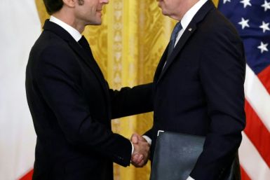 US President Joe Biden and French President Emmanuel Macron shake hands after a joint press conference in the East Room of the White House in Washington, DC, on December 1, 2022