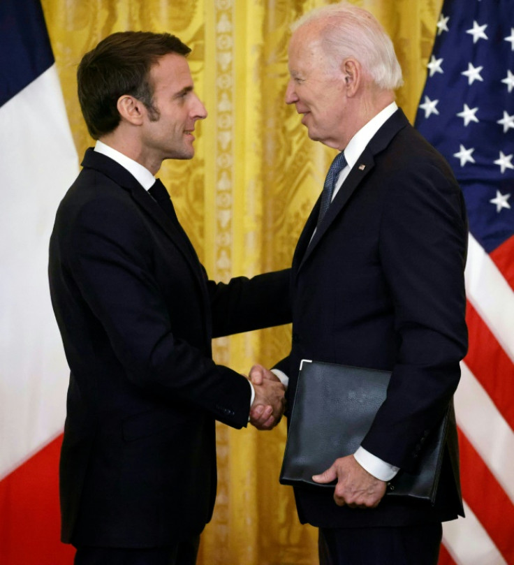 US President Joe Biden and French President Emmanuel Macron shake hands after a joint press conference in the East Room of the White House in Washington, DC, on December 1, 2022