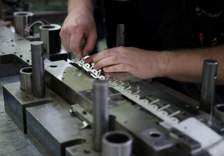 A worker at contract precision stamping company Brandauer's factory in Birmingham, Britain