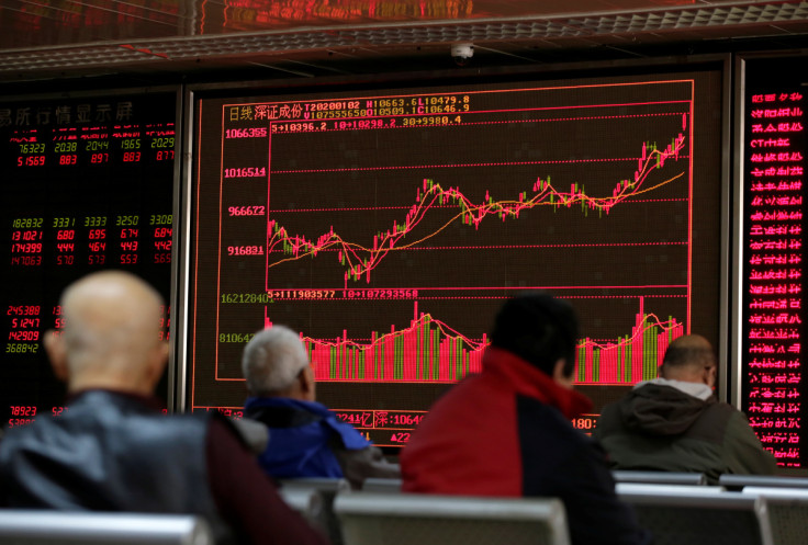 A board shows stock information at a brokerage office in Beijing